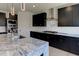 Modern kitchen featuring granite counters, stainless steel appliances, and dark cabinetry at 3066 Reserve Ct Sw, Conyers, GA 30094