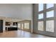 Open-concept layout featuring a spacious living room with high windows and access to the modern kitchen at 3066 Reserve Ct Sw, Conyers, GA 30094