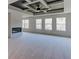Spacious living room featuring ceiling detail, fireplace, and lots of windows at 3066 Reserve Ct Sw, Conyers, GA 30094