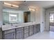 Bright bathroom featuring double vanity, modern fixtures, and glass enclosed shower with soaking tub at 3066 Reserve Sw Ct, Conyers, GA 30094