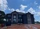 Striking two-story home with large windows and stone accents, set against a bright blue sky at 3066 Reserve Sw Ct, Conyers, GA 30094