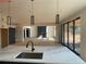 Bright kitchen with stainless steel fixtures and access to a living space with a fireplace and sliding glass doors at 3066 Reserve Sw Ct, Conyers, GA 30094