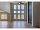 Bright living room with floor to ceiling windows, a modern fan, and fireplace at 3066 Reserve Sw Ct, Conyers, GA 30094