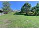 Large backyard with green grass and partial fence and mature trees providing privacy at 3168 Sag Harbor Ct, Buford, GA 30519