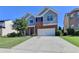Two-story home with brick and siding, attached two-car garage, and well-maintained lawn in a residential area at 3168 Sag Harbor Ct, Buford, GA 30519