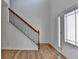 Home foyer featuring hardwood floors, staircase with rod iron spindles and front door with glass accents at 3168 Sag Harbor Ct, Buford, GA 30519