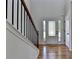 The foyer welcomes guests with hardwood floors, a decorative front door, and staircase at 3168 Sag Harbor Ct, Buford, GA 30519