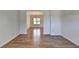 Hallway showing hardwood floors and white trim, leading to other rooms in the home at 3168 Sag Harbor Ct, Buford, GA 30519