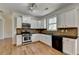Modern kitchen with white cabinets, stainless steel appliances, and dark countertops at 3168 Sag Harbor Ct, Buford, GA 30519