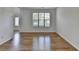 Living room with hardwood floors and a view of the front door and large window at 3168 Sag Harbor Ct, Buford, GA 30519