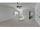 Bright main bedroom with plush carpet, ceiling fan, ensuite bathroom access and natural light at 3168 Sag Harbor Ct, Buford, GA 30519