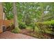 Brick patio surrounded by lush landscaping and mature trees at 68 Willow Ne Gln, Atlanta, GA 30342