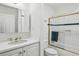Clean bathroom featuring a glass shower door, white vanity, and classic fixtures for a refreshing experience at 68 Willow Ne Gln, Atlanta, GA 30342