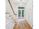 Elegant foyer with hardwood floors, staircase, and double doors leading outside, filling the space with natural light at 68 Willow Ne Gln, Atlanta, GA 30342