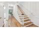 Inviting hallway featuring hardwood floors and a staircase with white banisters, offering a classic touch at 68 Willow Ne Gln, Atlanta, GA 30342