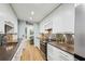 Modern kitchen featuring stainless steel appliances, sleek cabinets, and a view into the living area at 68 Willow Ne Gln, Atlanta, GA 30342