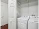Convenient laundry room featuring a washer and dryer with storage shelving at 68 Willow Ne Gln, Atlanta, GA 30342