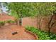Enclosed patio with brick pavers, brick walls, green foliage and trees at 68 Willow Ne Gln, Atlanta, GA 30342