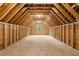 Spacious unfinished attic with a window and exposed wood beams, ready for customization at 131 Forsyth Park Ln, Woodstock, GA 30188