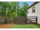Private backyard with wood fence, lush trees and lawn, plus an outdoor grill and cooking area at 131 Forsyth Park Ln, Woodstock, GA 30188