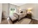 Comfortable bedroom with a window view, neutral tones and a stylish upholstered bed at 131 Forsyth Park Ln, Woodstock, GA 30188