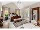 Bedroom with vaulted ceiling, elegant furniture, and natural light at 131 Forsyth Park Ln, Woodstock, GA 30188