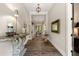 Elegant entryway featuring wood floors, a decorative console table, and view of the dining room at 131 Forsyth Park Ln, Woodstock, GA 30188