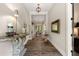Elegant entryway with hardwood floors, decorative console table, and chandelier, creating a sophisticated entrance at 131 Forsyth Park Ln, Woodstock, GA 30188