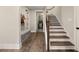 Inviting foyer with hardwood floors, built-in bench and access to the laundry room via a doorway at 131 Forsyth Park Ln, Woodstock, GA 30188