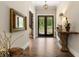 Inviting foyer features hardwood floors, elegant lighting, and a view to the outdoors at 131 Forsyth Park Ln, Woodstock, GA 30188