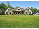 Charming home featuring stone accents, a large front yard, and a welcoming front porch at 131 Forsyth Park Ln, Woodstock, GA 30188