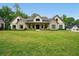 Beautiful home featuring a well-manicured lawn, stone accents, and a covered porch perfect for relaxing at 131 Forsyth Park Ln, Woodstock, GA 30188