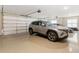Spacious three car garage featuring epoxy flooring, overhead lighting, and an insulated garage door at 131 Forsyth Park Ln, Woodstock, GA 30188