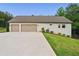 Detached two car garage featuring wide driveway and well-maintained lawn at 131 Forsyth Park Ln, Woodstock, GA 30188