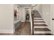 Bright hallway with hardwood floors, staircase, and built-in bench and storage at 131 Forsyth Park Ln, Woodstock, GA 30188
