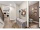 Hallway with bench and storage, and adjacent powder room at 131 Forsyth Park Ln, Woodstock, GA 30188