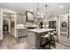 Spacious kitchen with a center island, pendant lights, and stainless steel appliances at 131 Forsyth Park Ln, Woodstock, GA 30188