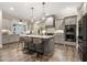 Spacious kitchen with a center island, stainless appliances, and ample cabinet space at 131 Forsyth Park Ln, Woodstock, GA 30188