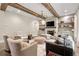 Comfortable living room with stone fireplace and wood beams for relaxed entertaining at 131 Forsyth Park Ln, Woodstock, GA 30188