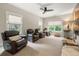 Comfortable living room with a ceiling fan and theater seating with backyard views at 131 Forsyth Park Ln, Woodstock, GA 30188