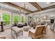 Open-concept living room featuring large windows and seamless flow to dining and kitchen at 131 Forsyth Park Ln, Woodstock, GA 30188