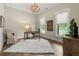 Bright office space with hardwood floors, two windows with natural light, and a decorative chandelier at 131 Forsyth Park Ln, Woodstock, GA 30188