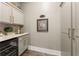 Well-organized pantry with custom cabinetry and ample countertop space and beverage fridge at 131 Forsyth Park Ln, Woodstock, GA 30188