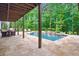 Backyard pool with waterfall features, ample seating, and lush greenery, perfect for outdoor enjoyment at 131 Forsyth Park Ln, Woodstock, GA 30188