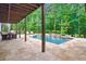 Backyard pool featuring stone patio, landscaping, and water feature at 131 Forsyth Park Ln, Woodstock, GA 30188