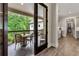 A view of the porch, with a table and chairs, and a glimpse into the kitchen area at 131 Forsyth Park Ln, Woodstock, GA 30188