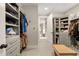 Organized walk-in closet with custom shelving, hanging rods, and carpeted flooring at 131 Forsyth Park Ln, Woodstock, GA 30188