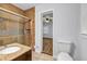 Modern bathroom featuring tiled shower with glass door, granite counters, and tile floors at 1747 Parkhill Dr, Decatur, GA 30032