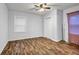 Bright bedroom with ceiling fan, closet, window, and wood-look flooring at 1747 Parkhill Dr, Decatur, GA 30032