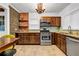 Kitchen with granite countertops, stainless steel appliances, wooden cabinets, and tile floors at 1747 Parkhill Dr, Decatur, GA 30032
